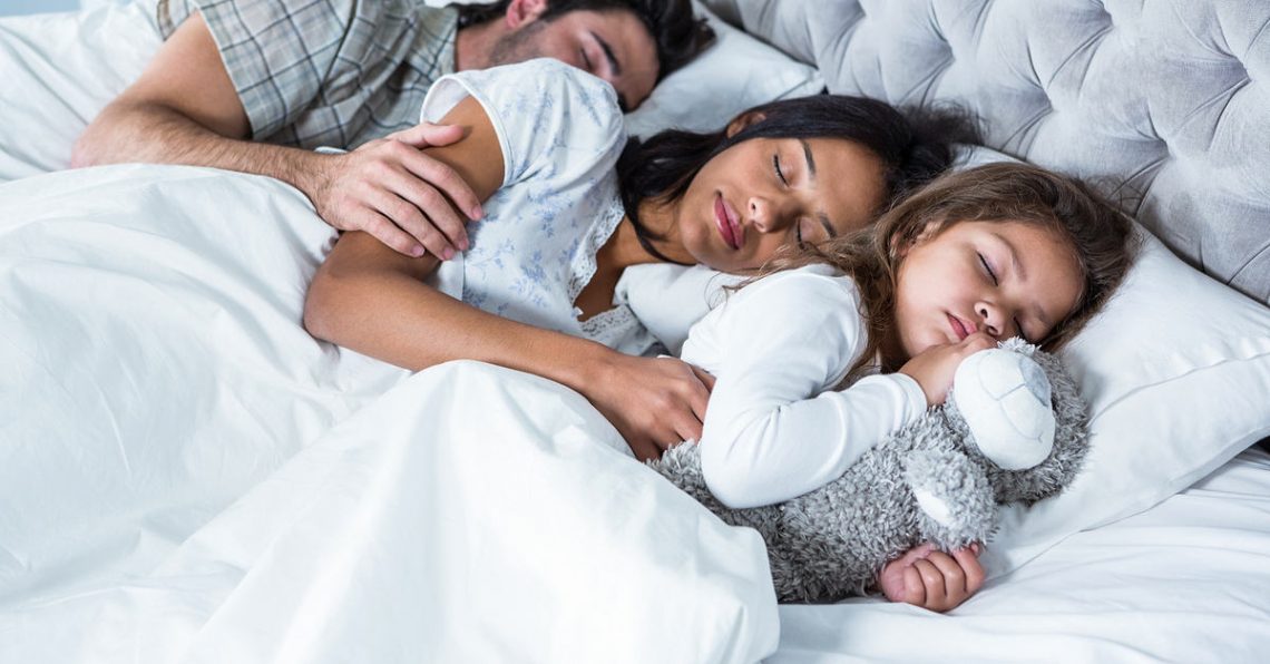 A family sleeping peacefully on their 100% Made In America bedding.